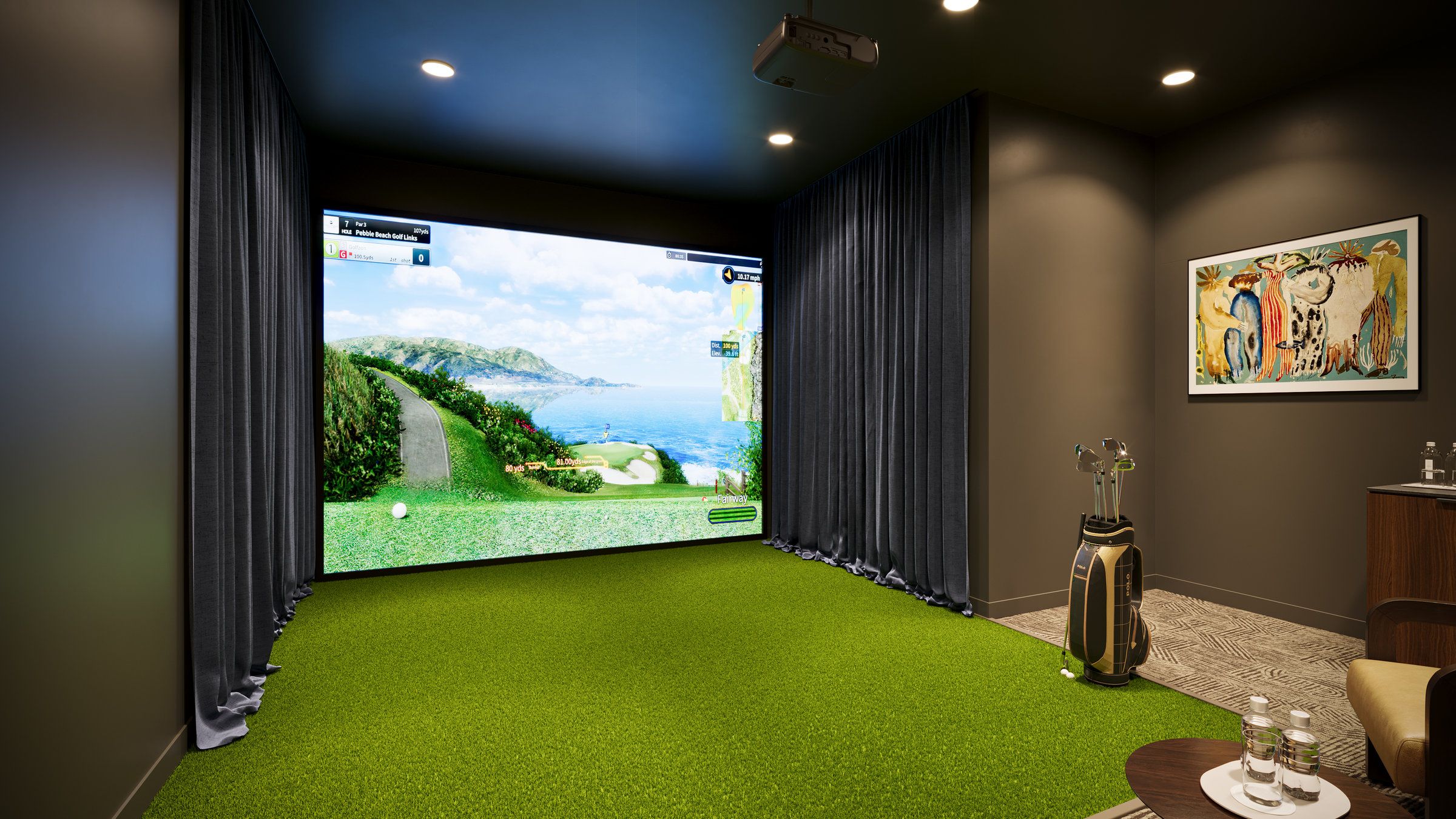 Indoor golf simulator room with a green turf floor, golf clubs, and a large screen displaying a coastal golf course.